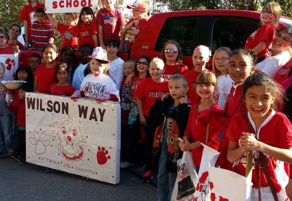 students and staff dressed in red and white